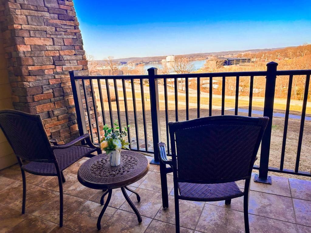 two chairs and a table on a balcony with a view at Fairway To Heaven At Four Season 2bed2bath Condo in Lake Ozark