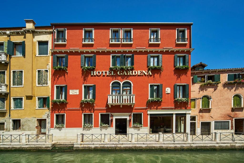 a red building on the side of a river at Hotel Gardena in Venice