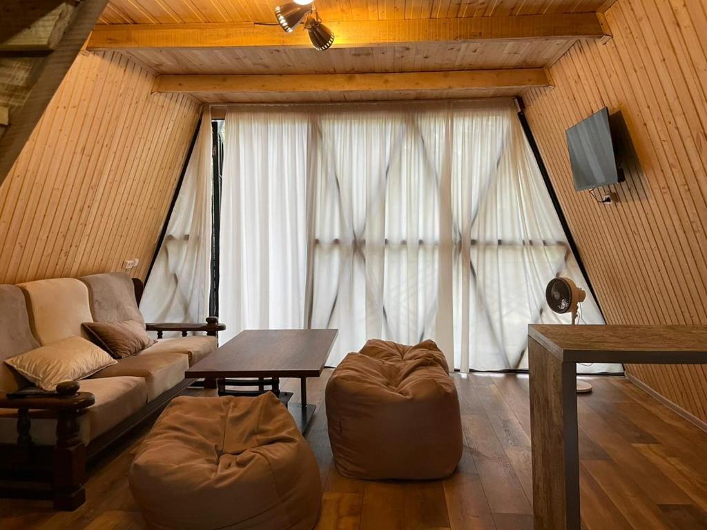 a living room with a couch and a table at Zen in Sataplia 