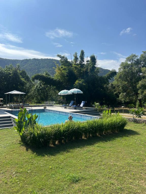 a swimming pool with a person standing next to it at Surya Bagh - A Luxury Hideaway - 20 minutes drive to Tehla gate, Sariska Tiger Reserve & 10 minute from Bhangarh Fort in Dogeta