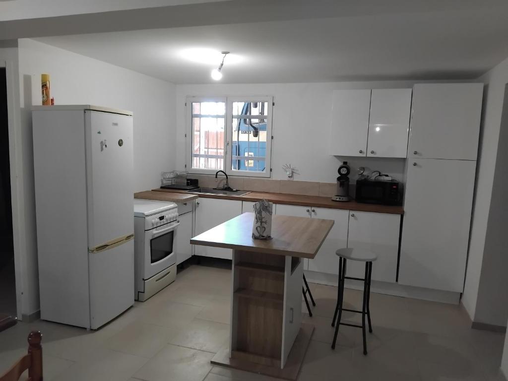 a kitchen with white appliances and a wooden table at appartement gites a la ferme in Barbentane