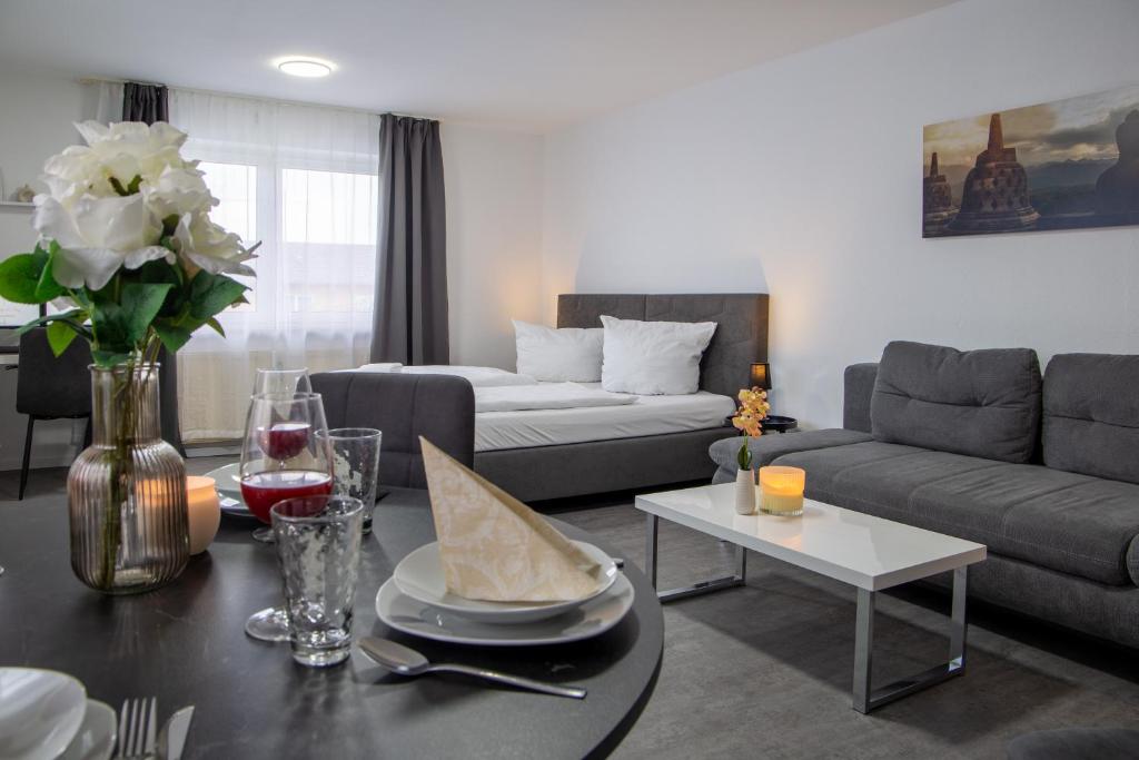 a living room with a couch and a table at Holiday&Stay, Apartment Relax, Küche, 85Zoll TV, WLAN in Weingarten