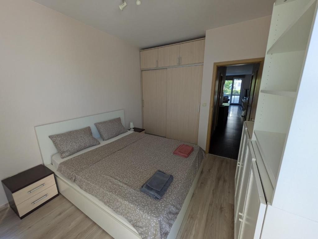 a small bedroom with a bed and a staircase at Modern Apartment in Sofia Near City Center in Sofia