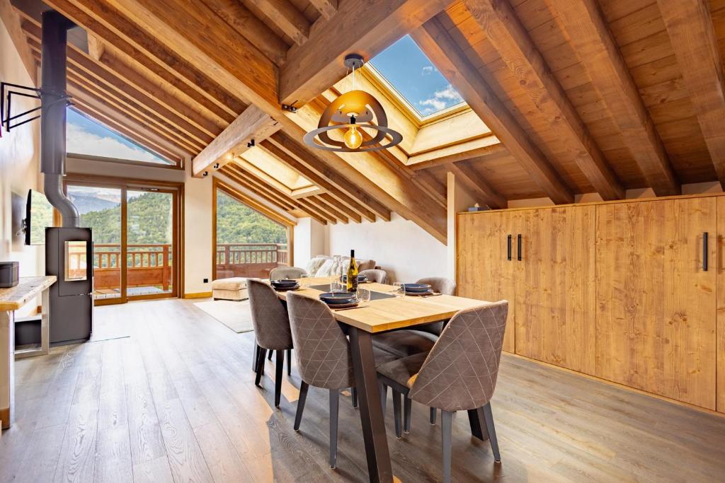 a kitchen and dining room with a table and chairs at Chalets Killington #4 - 4 guests in Les Allues