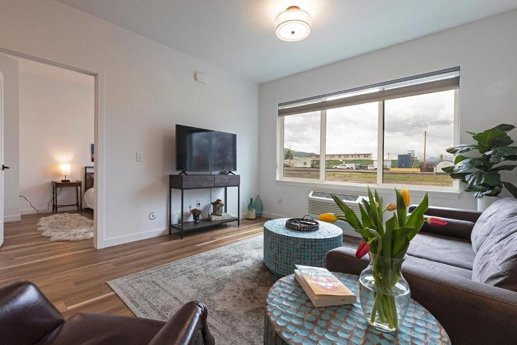 a living room with a couch and a tv at The Railway Flats 101 in Missoula