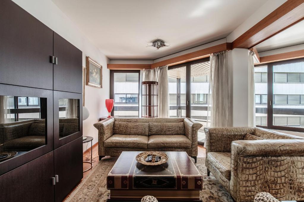 a living room with a couch and a table at Yamina Luxury Apartment by Quokka 360 - Next to Lido di Lugano in Lugano