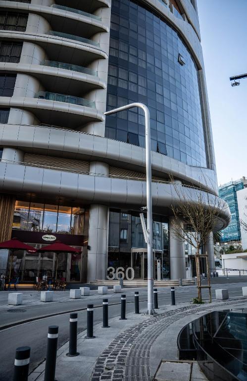 a street light in front of a tall building at 360 Luxury One Bedroom Suite in Nicosia