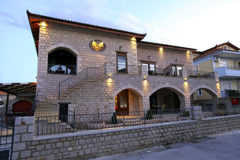 a brick building with stairs and lights on it at Myral Guesthouse in Nafplio