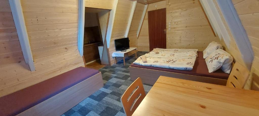 a small bedroom with a bed and a desk at Penzion Svojanov in Svojanov