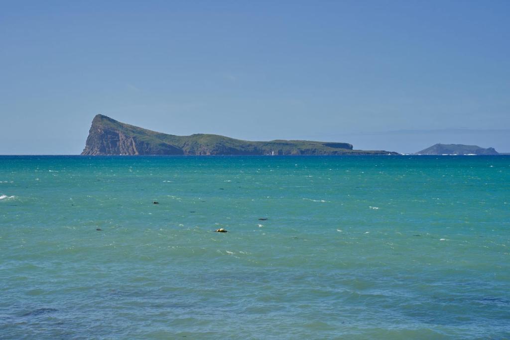 a large body of water with an island in the background at Villa Océana, 2 bedrooms, sea view and beach access in Cap Malheureux