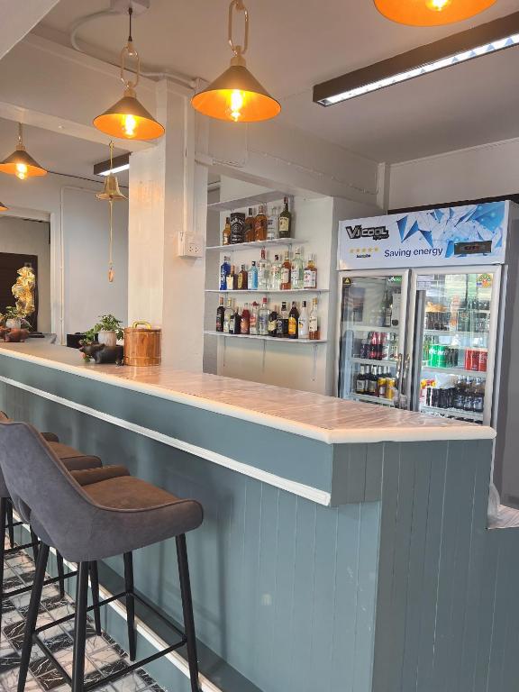a bar in a restaurant with two stools at Sherly 888 Hotel in Hua Hin