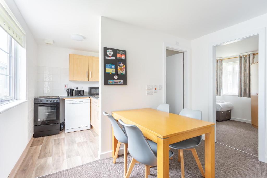 a kitchen and dining room with a wooden table and chairs at North Devon Getaways in Ilfracombe