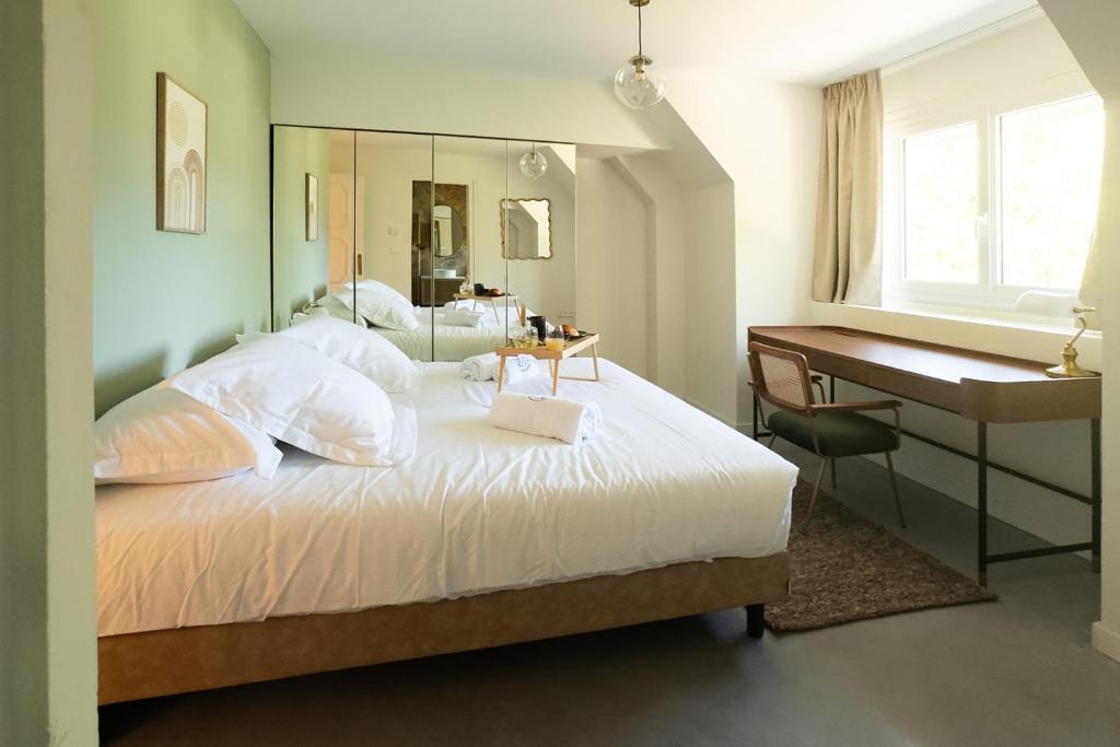 a bedroom with a bed with a desk and a piano at La Louvière in Villard-de-Lans