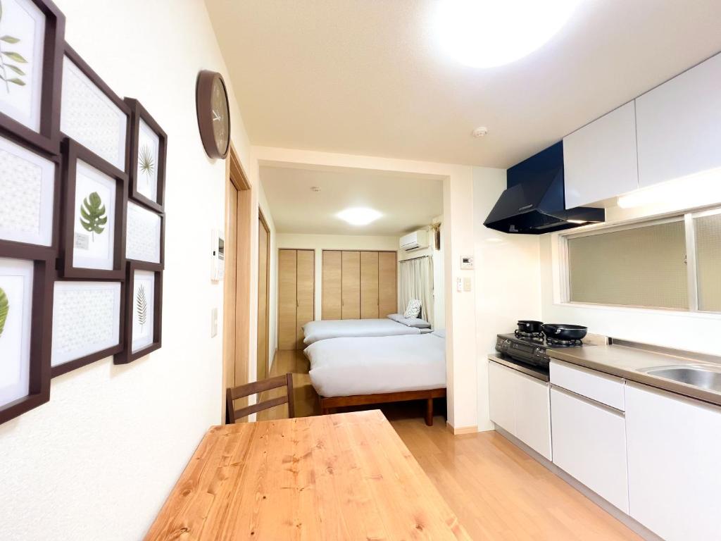 a kitchen with a table and a bed in a room at Asakusa 2DB Stuido Free Wi-Fi in Tokyo