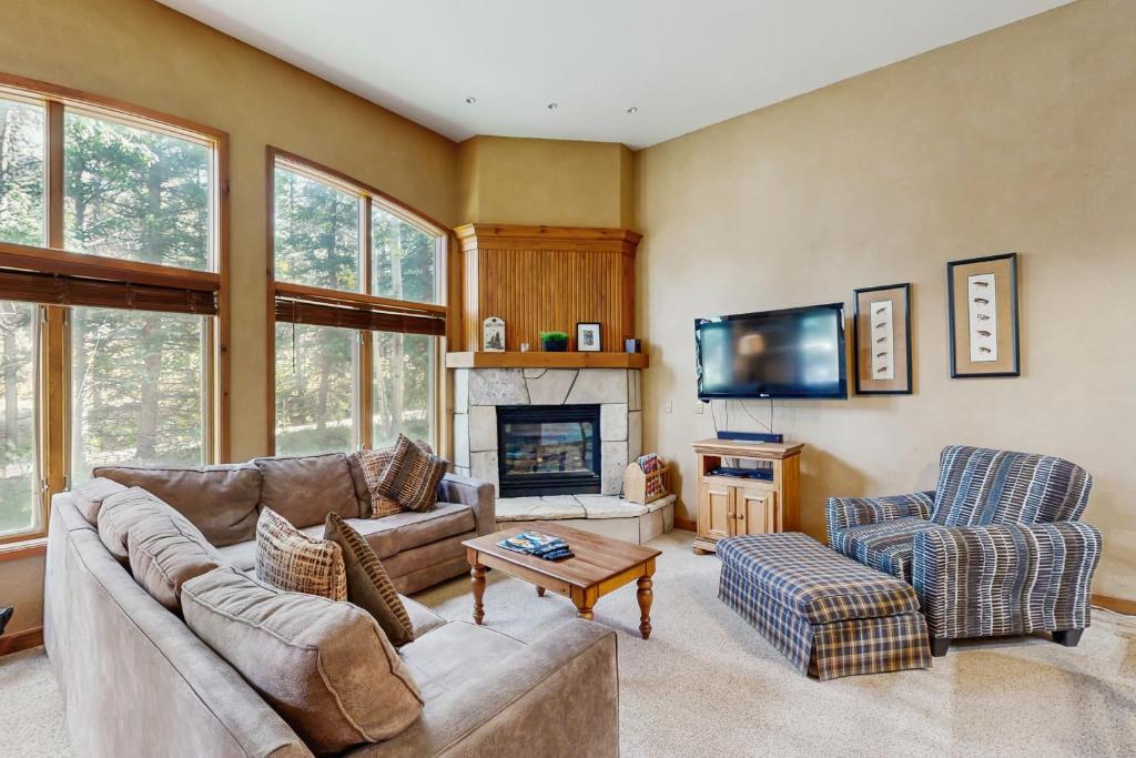 a living room with a couch and a fireplace at Riverbend Lodge #001 in Breckenridge