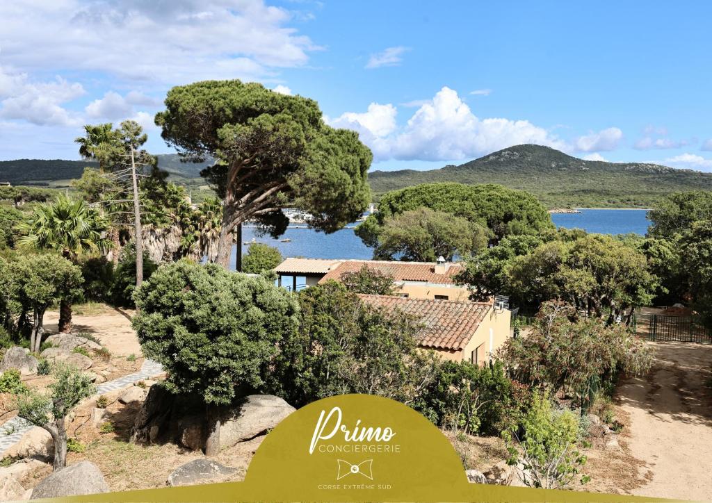 a view of a house with trees and a lake at U Mare - T2 cabine avec vue mer, plage & piscine in Pianottoli-Caldarello