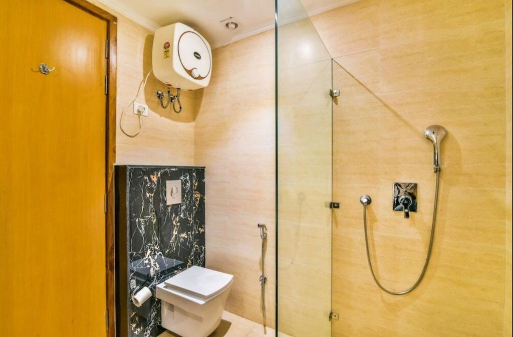 a bathroom with a shower and a toilet at HOTEL Corporate Suite Near Delhi Terminal 3 With - Free Airport Pickup in New Delhi