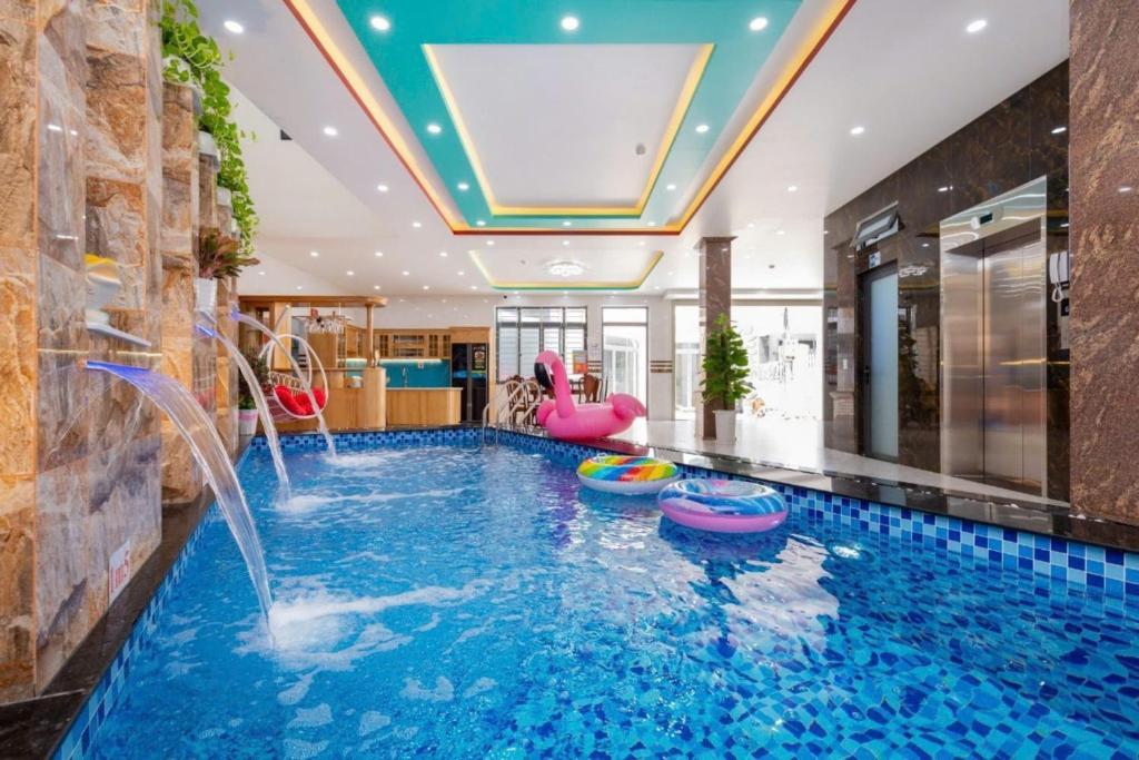 a pool with a water slide in a house at Villas & Hotel 126 Vũng Tàu in Vung Tau
