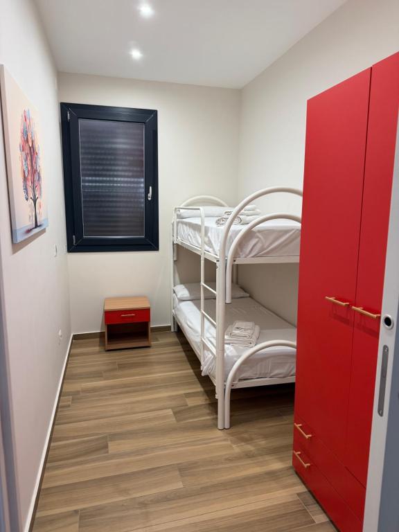 a small room with a bunk bed and a window at SICILIA FIERA Apartment in Misterbianco