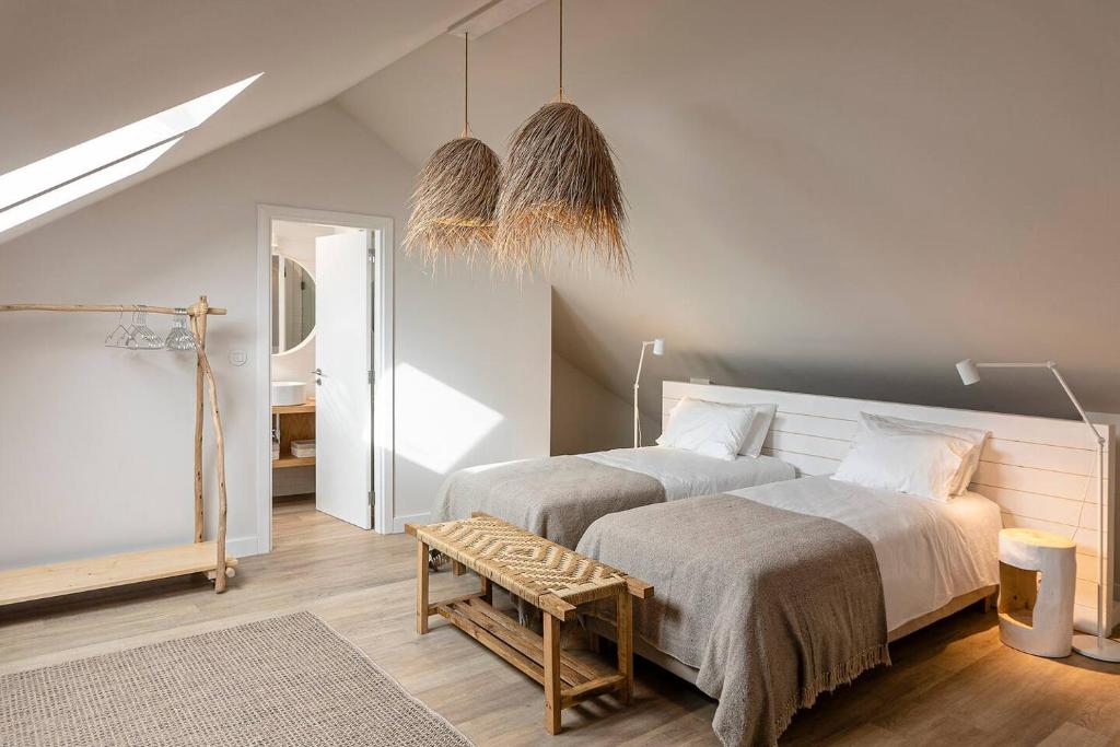 a bedroom with two beds and a table at Charming Design House In Montijo With Garden - 41 in Montijo