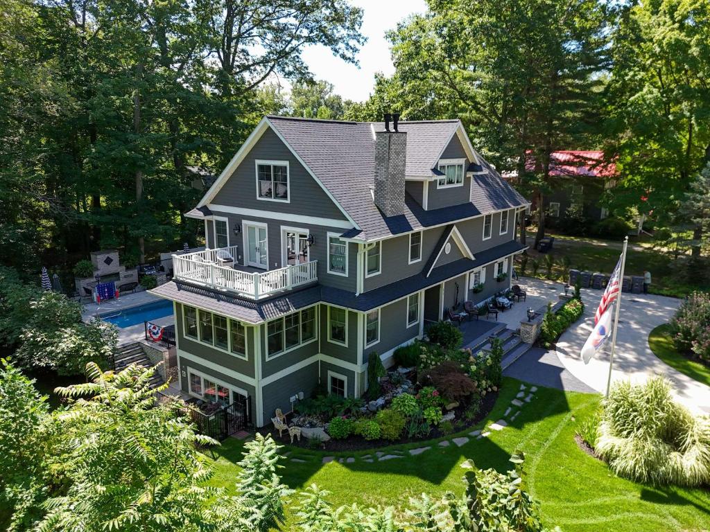 an aerial view of a blue house with a yard at Fern Creek in South Haven