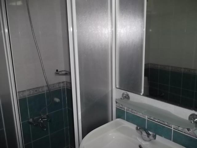 a bathroom with a sink and a mirror and a shower at Antik Ridvan Hotel in Çeşme