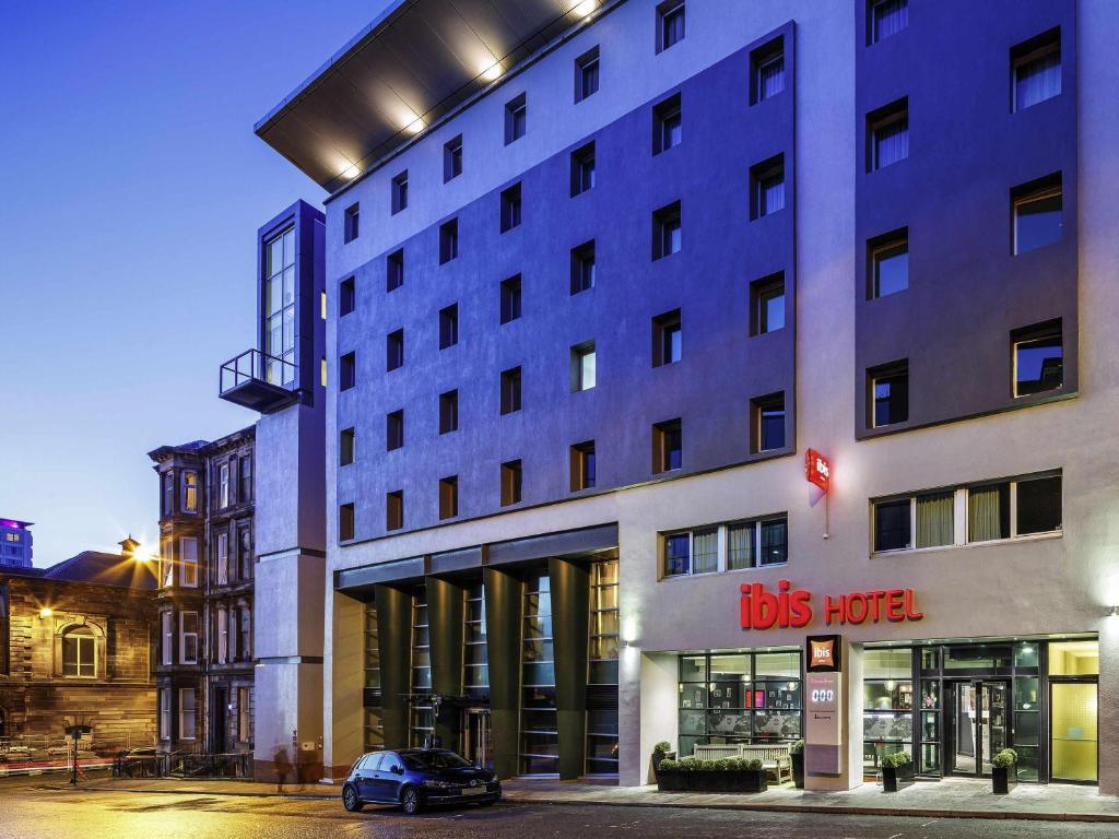 a building with a car parked in front of it at ibis Glasgow City Centre – Sauchiehall St in Glasgow