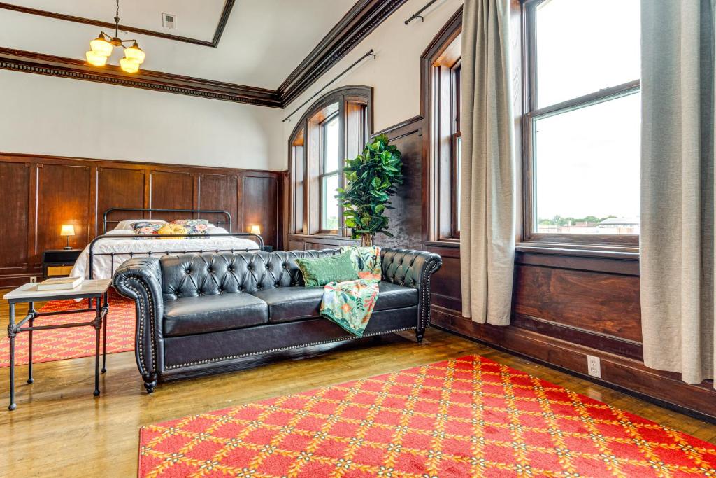 a living room with a couch and a bed at Modern Elegance: Timeless Crawfordsville Studio! in Crawfordsville