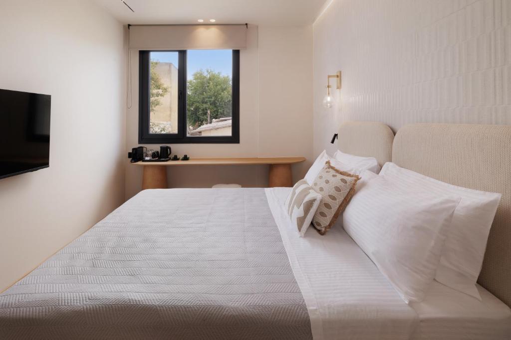 Ένα ή περισσότερα κρεβάτια σε δωμάτιο στο Avia