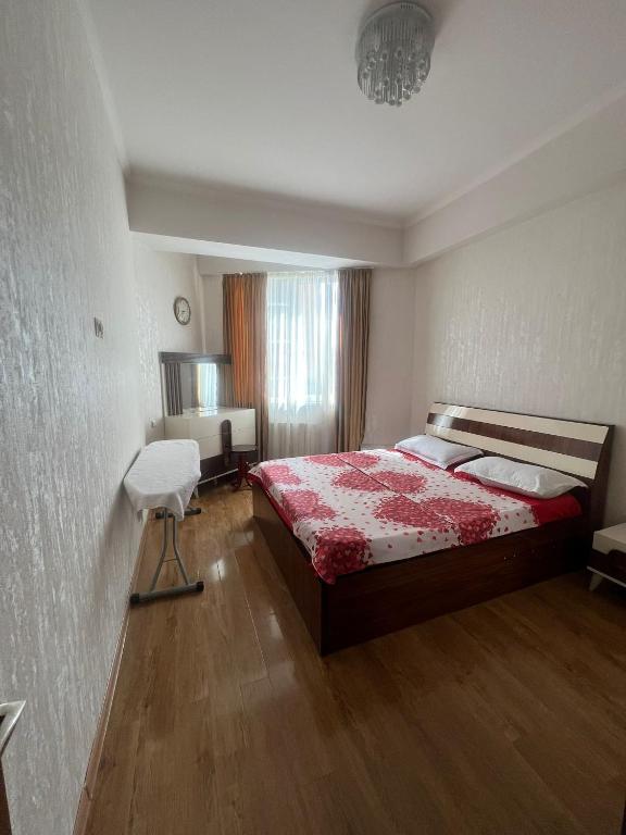 a bedroom with a bed and a chair in it at Ete in Tbilisi City
