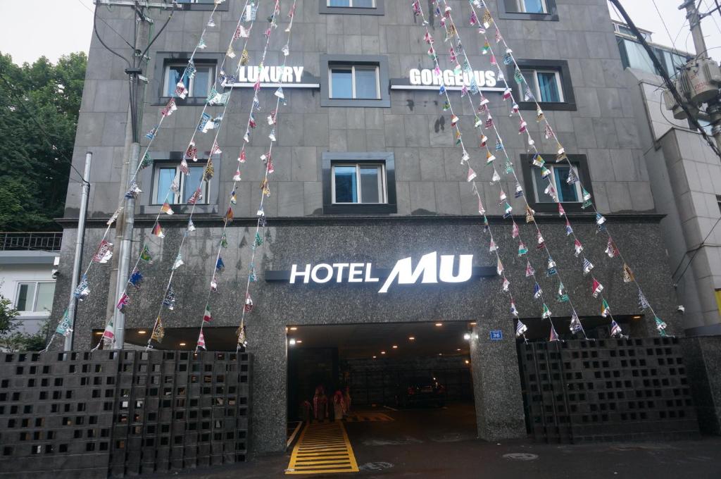 a hotel mcu with christmas lights hanging from it at MU Hotel in Busan