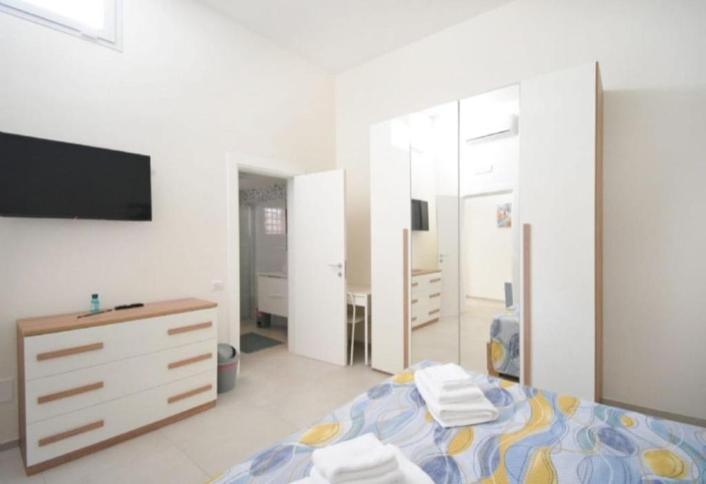 a bedroom with a bed and a dresser and a tv at Casa Carmela in San Vito dei Normanni