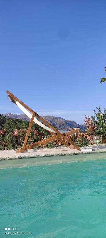 a wooden structure sitting on top of the water at Casa Ermida in Pincães