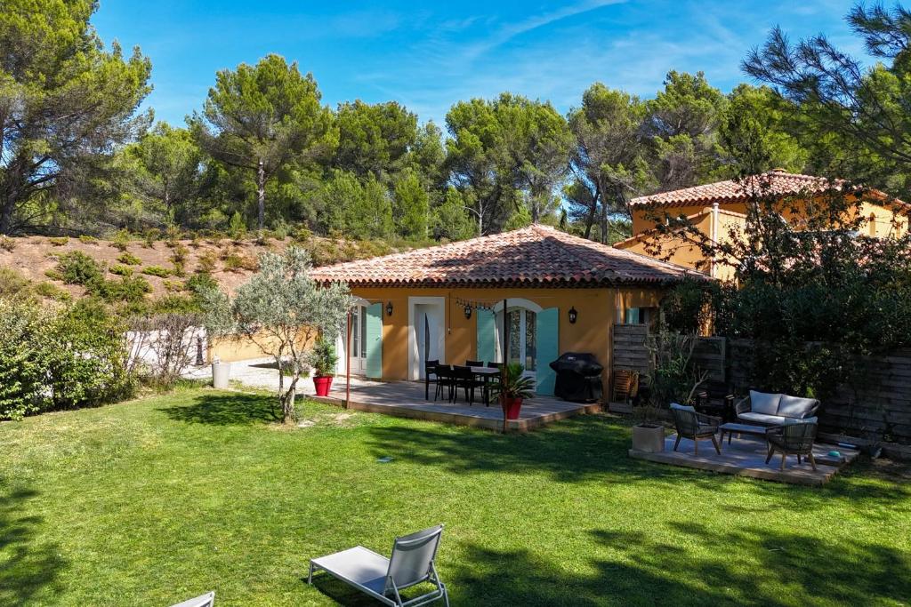 a small house in a field with a yard at The Maisonnette in the pines in Ventabren