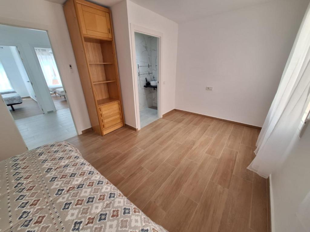Cama o camas de una habitación en Apartamentos Playa del Cura