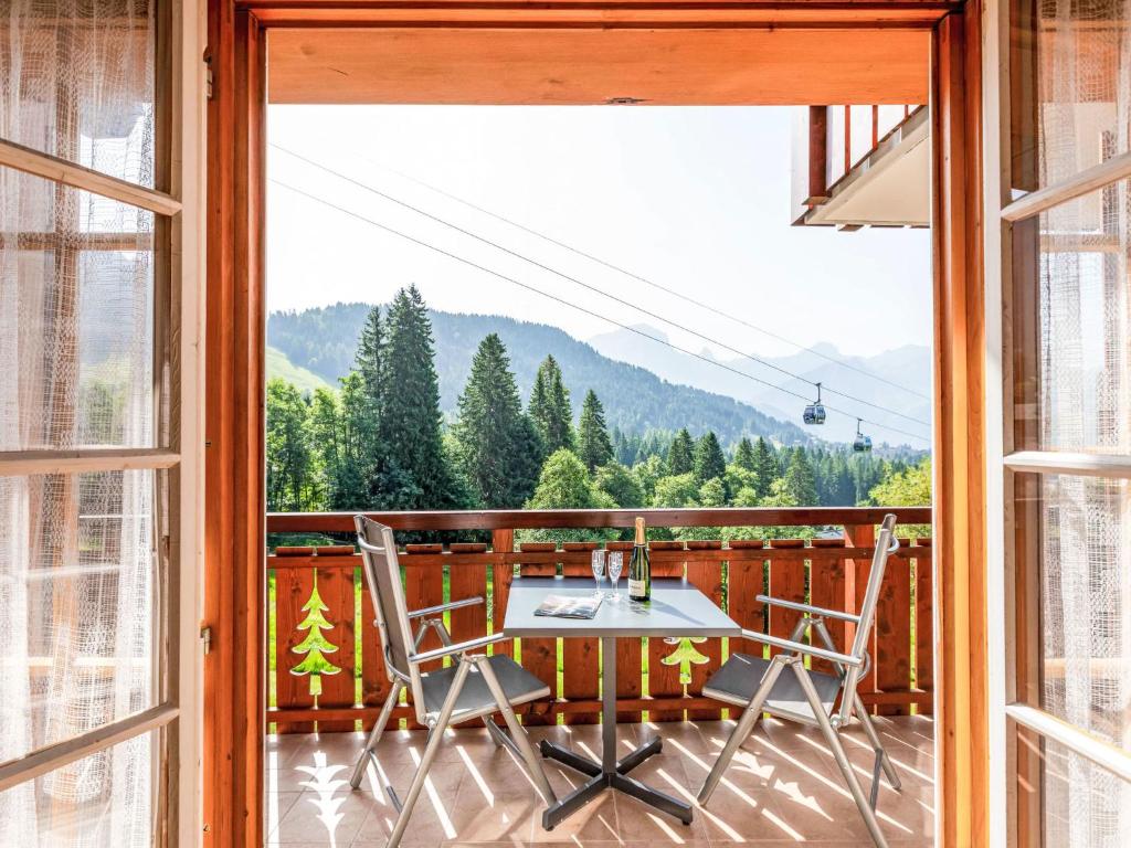 a room with a table and chairs on a balcony at Apartment Vermont 8 by Interhome in Villars-sur-Ollon