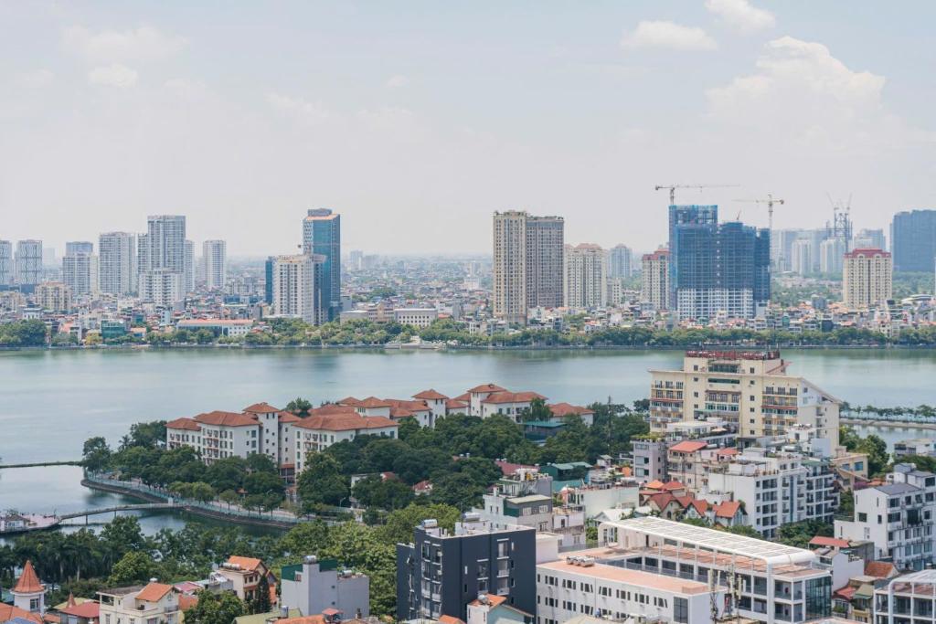 a view of a city with a river and buildings at D’Leroi Soleil - Westlake Suite & Apartment in Hanoi