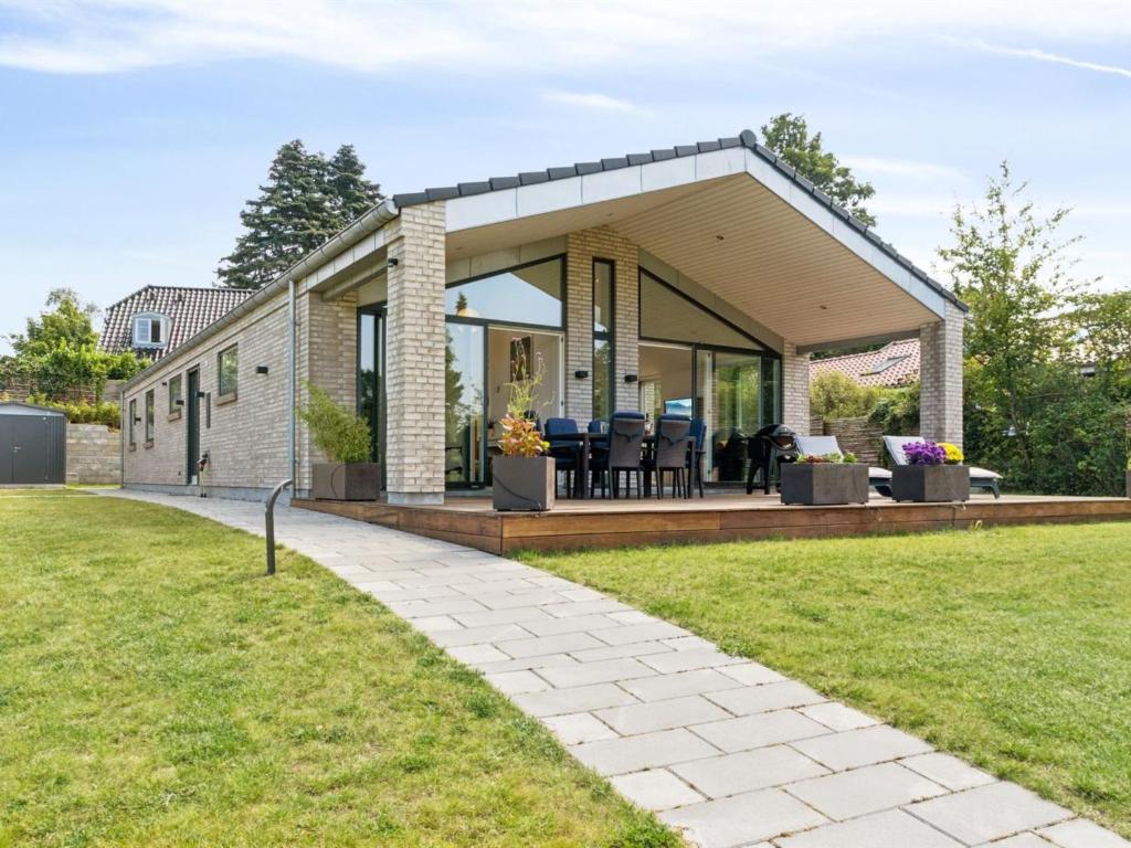 a brick house with a large patio and grass at Holiday Home Troels - 945m from the sea by Interhome in Hornbæk