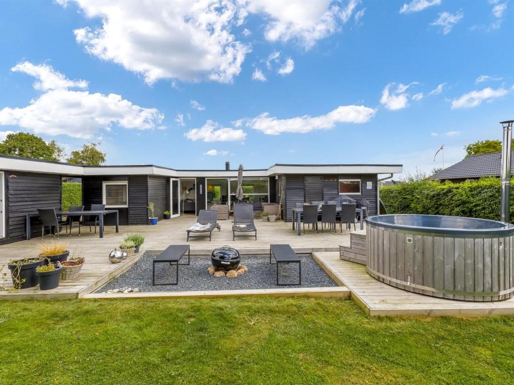 a backyard with a deck and a fire pit at Holiday Home Adia - 500m from the sea by Interhome in Hejlsminde