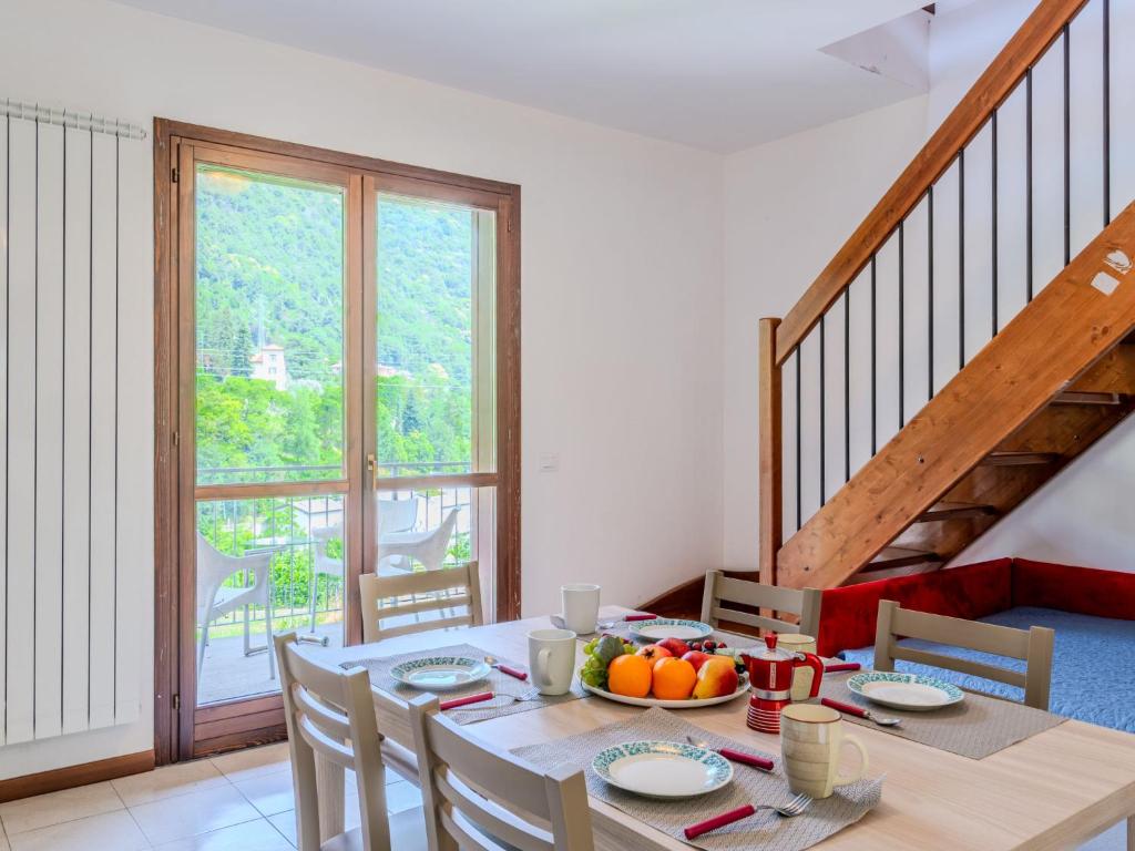 a dining room with a table with a bowl of fruit on it at Apartment Borgo Castello-4 by Interhome in Argegno