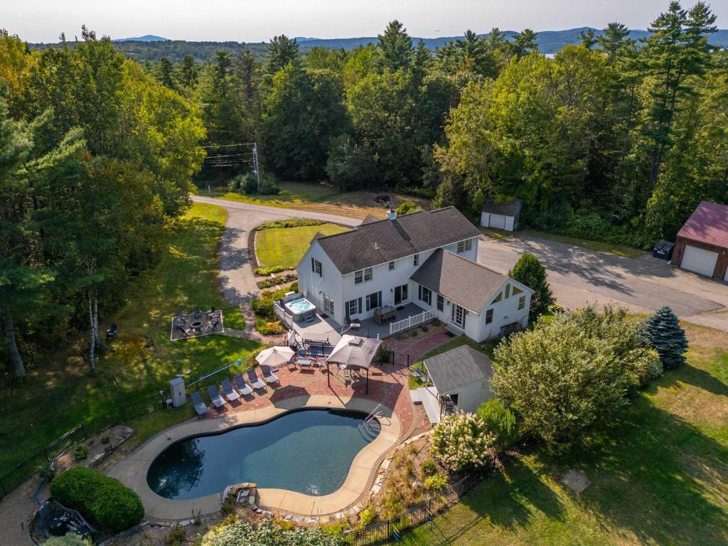 an aerial view of a house with a swimming pool at Gilford Getaway - Pool & Hot Tub - Lakes Region in Gilford