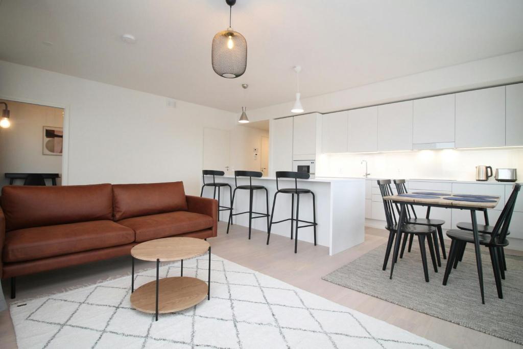 a living room with a couch and a table at Spacious Apartment for 2 with Sauna in V in Iso-Heikkilä