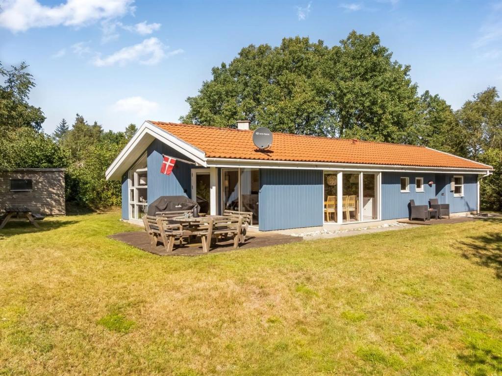 a small house with a picnic table and a grill at Holiday Home Elizabeth - 150m to the fjord by Interhome in Furland