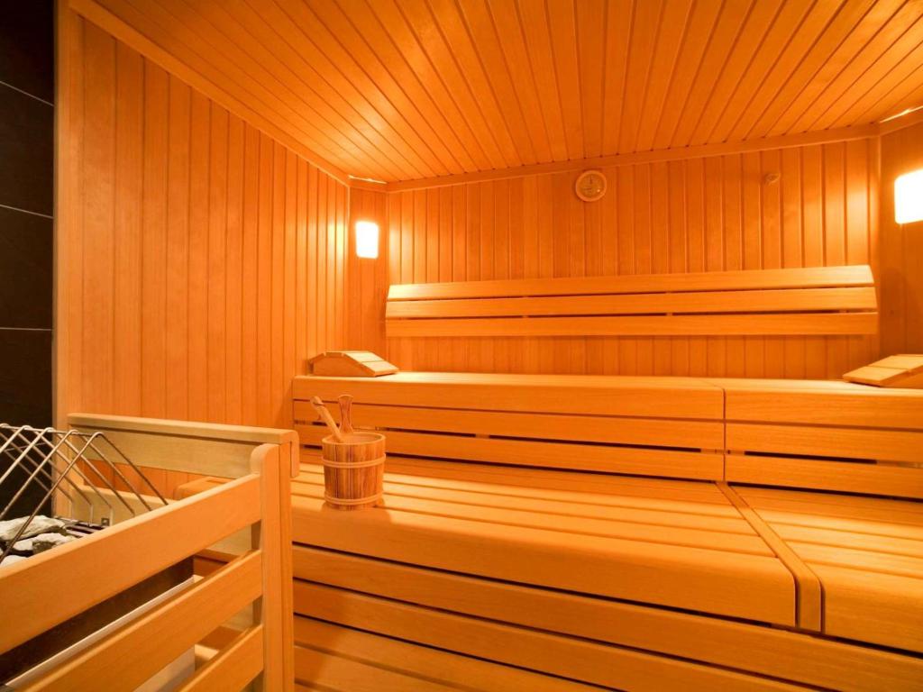 a sauna with wooden walls and a wooden floor at Studio Studio Taxacher by Interhome in Krinberg