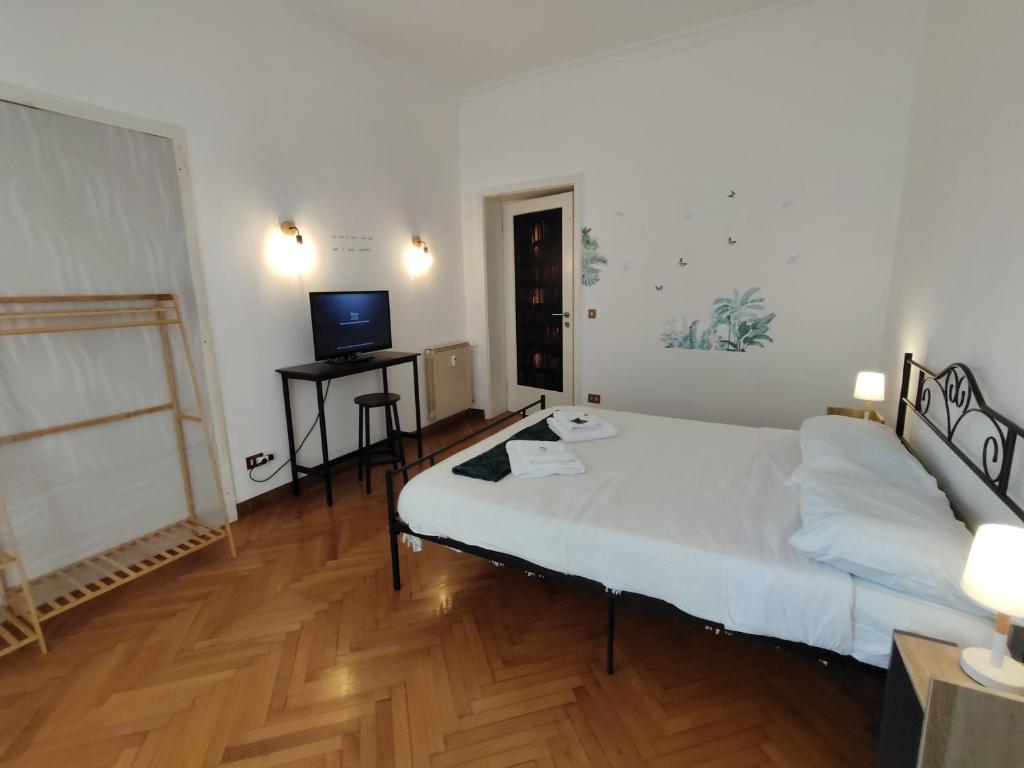 a bedroom with a bed and a television in it at Dock Bay Lodge Hostel in Trieste