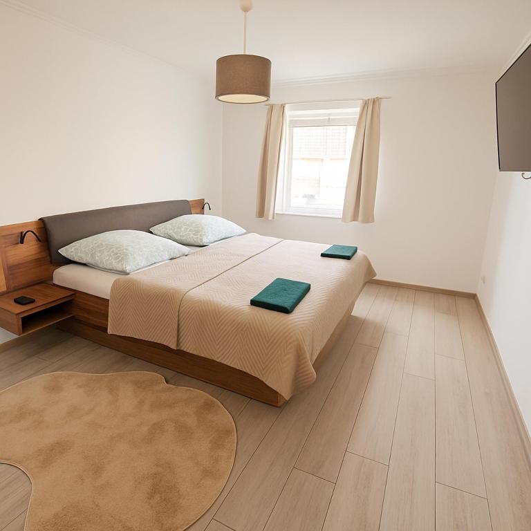 a white bedroom with a bed and a window at Koblenz Exclusive Residence in Koblenz