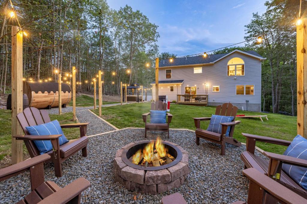 a backyard with a fire pit and chairs and a house at Best Deal In The Poconos! in Pocono Country Place