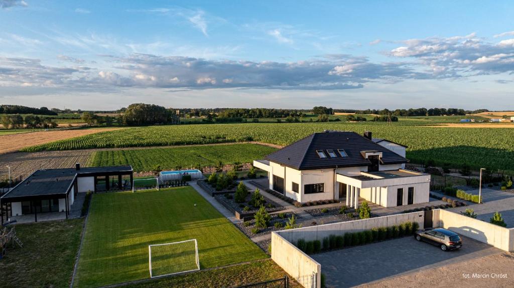 an aerial view of a house with a soccer field at Aura dom na wynajem in Jeziorki