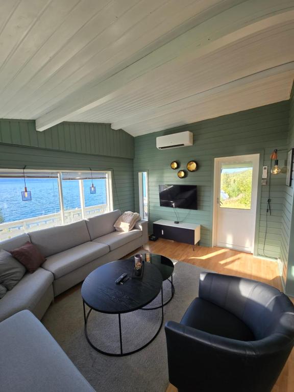 a living room with a couch and a table at Lyngenfjord view in Engnes