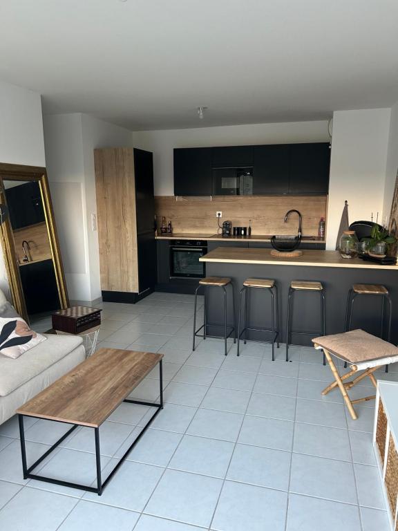 a living room with a couch and a kitchen at Appartement proche mer in Le Muy